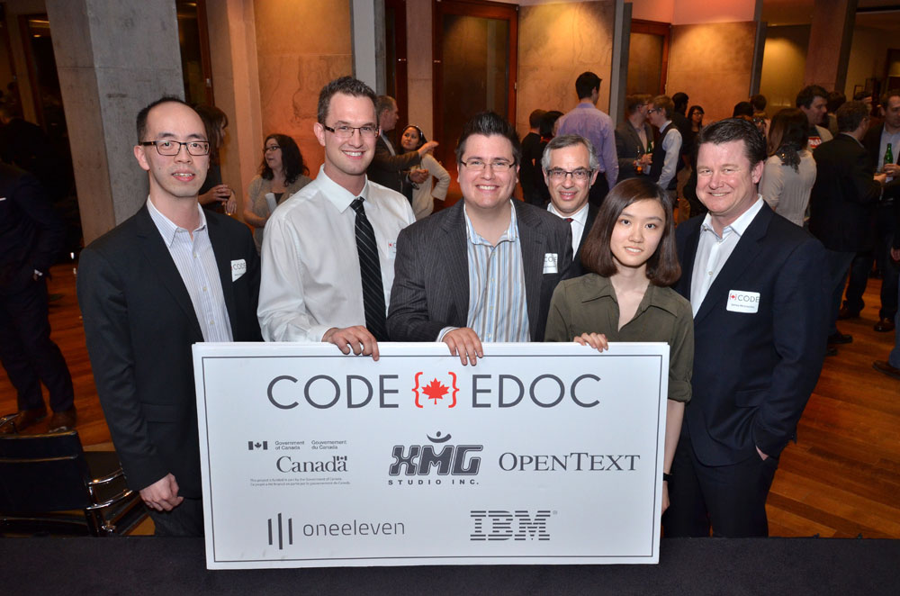 CODE winning teams with judges Treasury Board President Tony Clement and James McGourlay, Senior VP, Global Customer Service, OpenText at the CODE Grand Finale